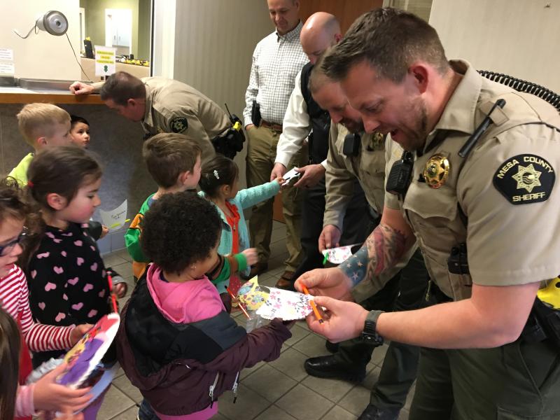 Photograph of deputies from the Sheriff's Office with a group of young children from New Emerson school