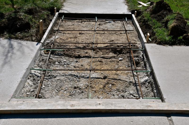 Photograph of Sidewalk Repair. Reinforcing rods in place sidewalk is being repaired for new concrete.