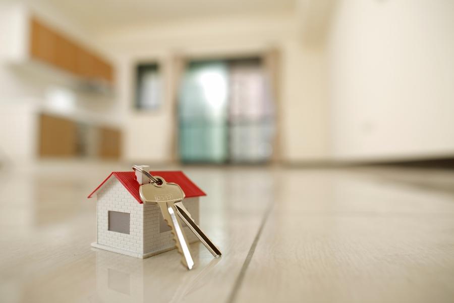 Tiny house with gold keys connected to it. 