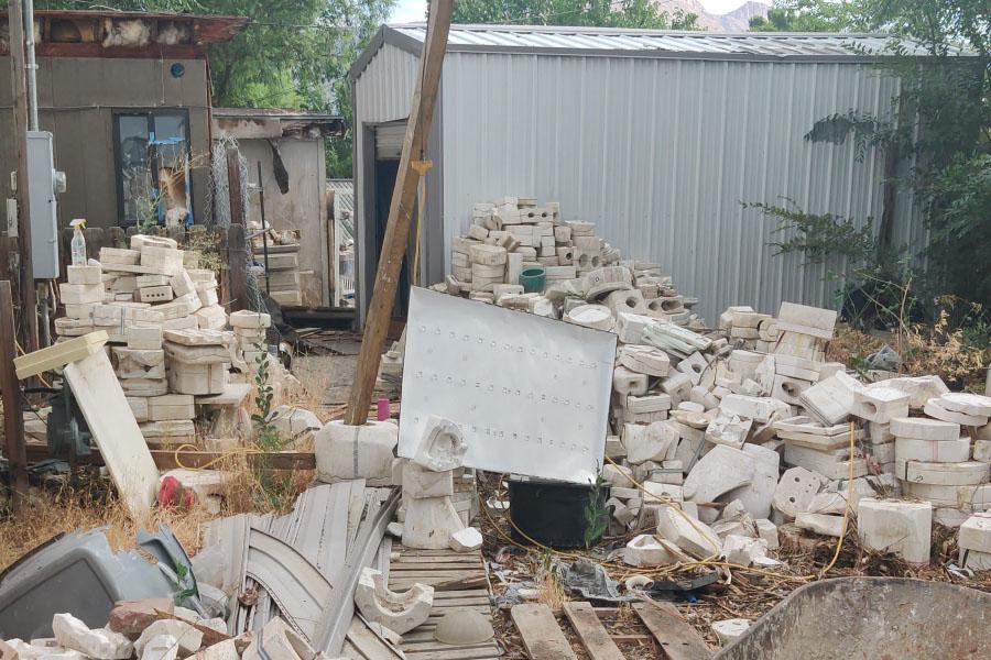 A property surrounded by junk and debris.