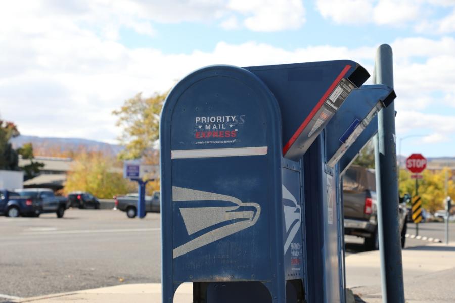 Blue United States Postal Service drop box. 