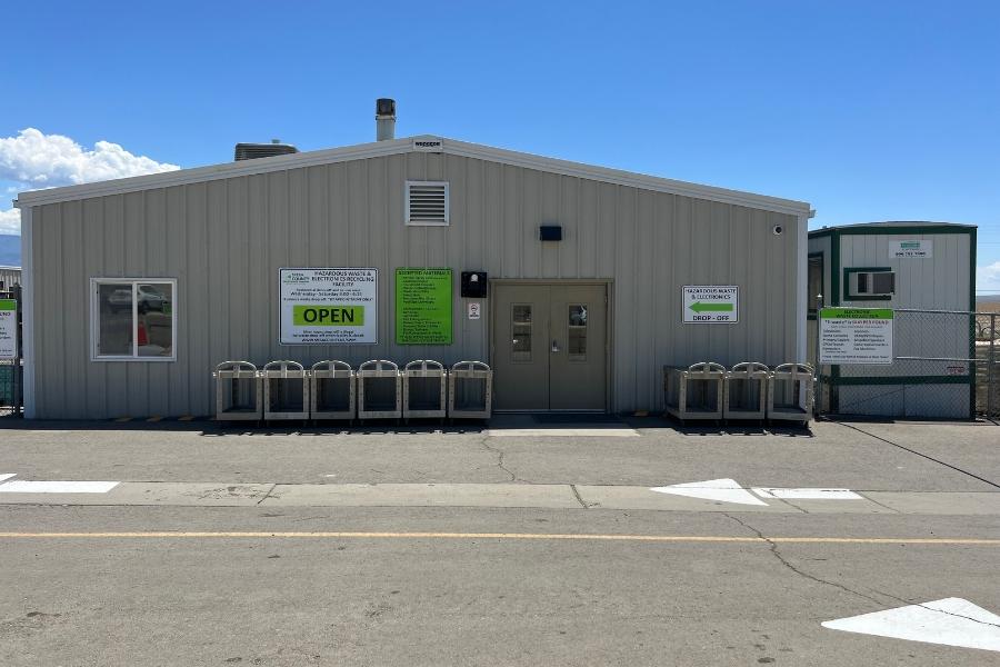 Grey Mesa County Hazardous Waste Disposal Facility with bright green signage. 