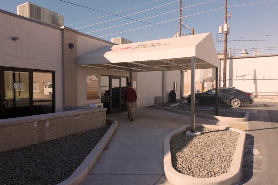 Man walking into white building (Mesa County Criminal Justice Services).
