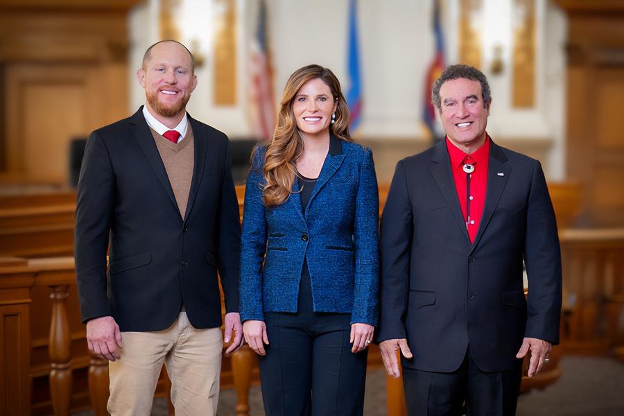 Three individuals (2025 Board of Mesa County Commissioners) smiling in group photo. 