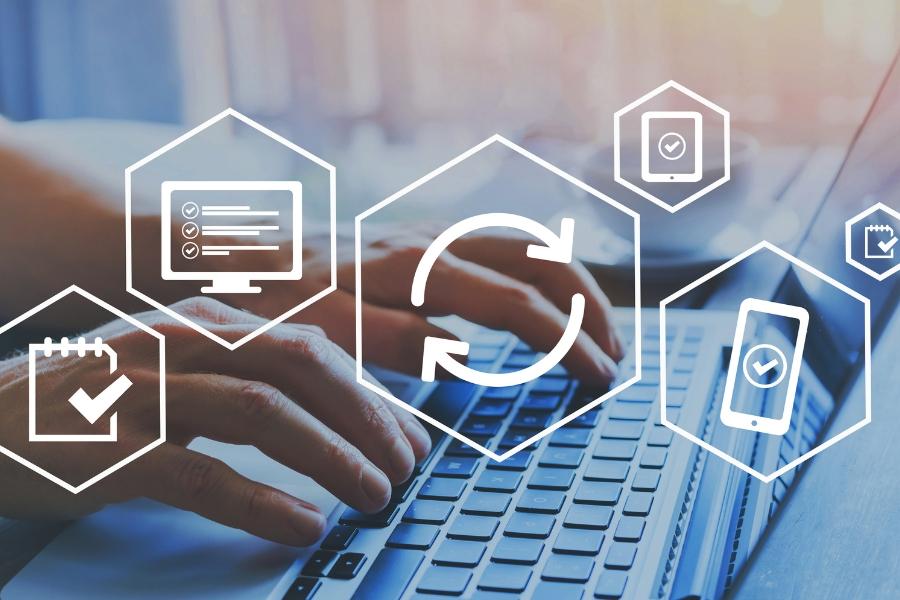 A person's hands are typing on a laptop with 6 white heptagon elements. 