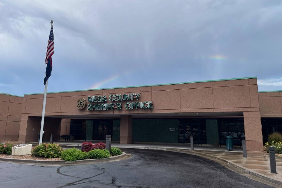 The Mesa County Sheriff's Office building with an American flag in front. 