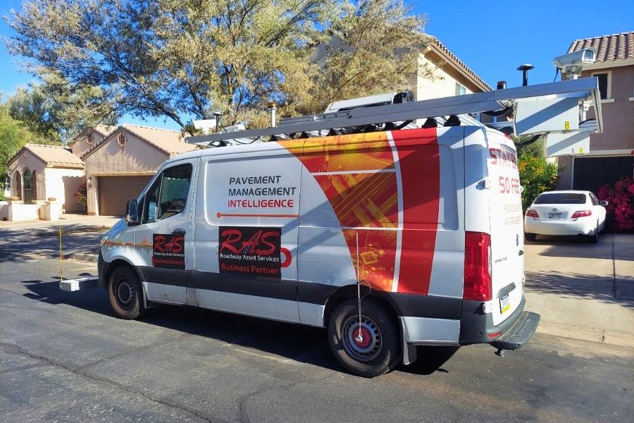 An orange and white data collection van that reads, Roadway Asset Services. 