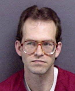 Inmate photo of James Genrich wearing a red jumpsuit. 