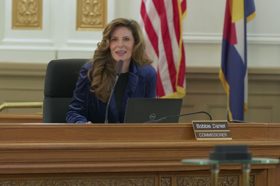 A woman speaking into a microphone.