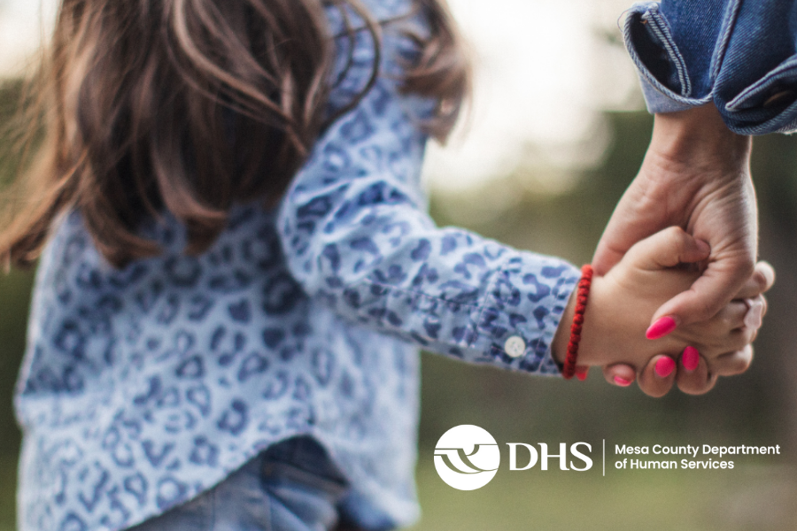 Daughter holding moms hand with white MCDHS logo