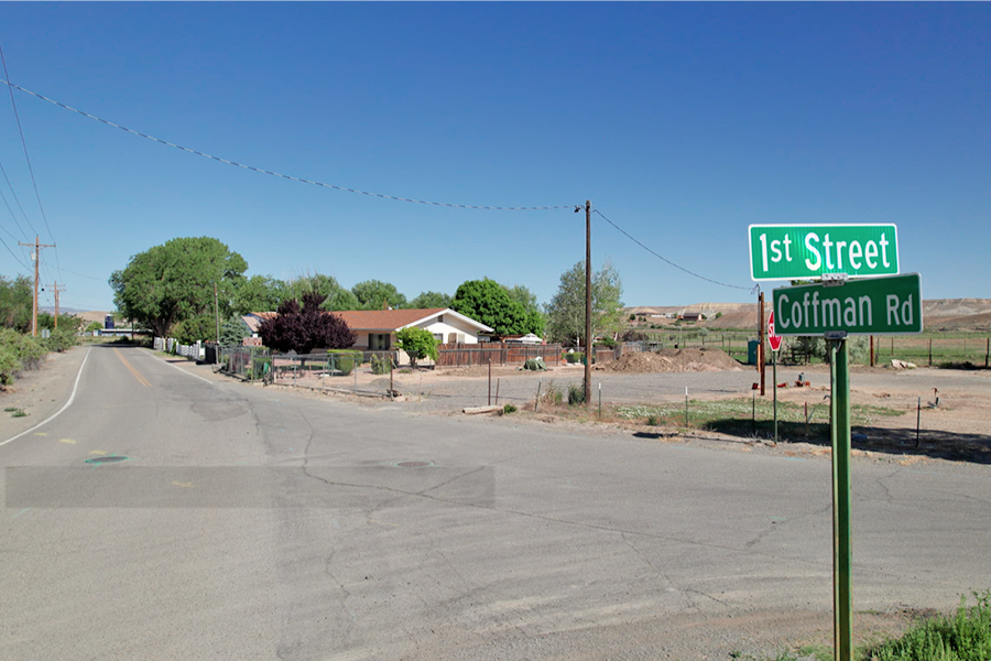 Intersection of Coffman Road and First Street in Whitewater, Colorado, showing a residential area, roadway pavement and street signs marking both roads. The intersection is one of the locations being evaluated as part of the Coffman Road Rehabilitation Phase II Project.