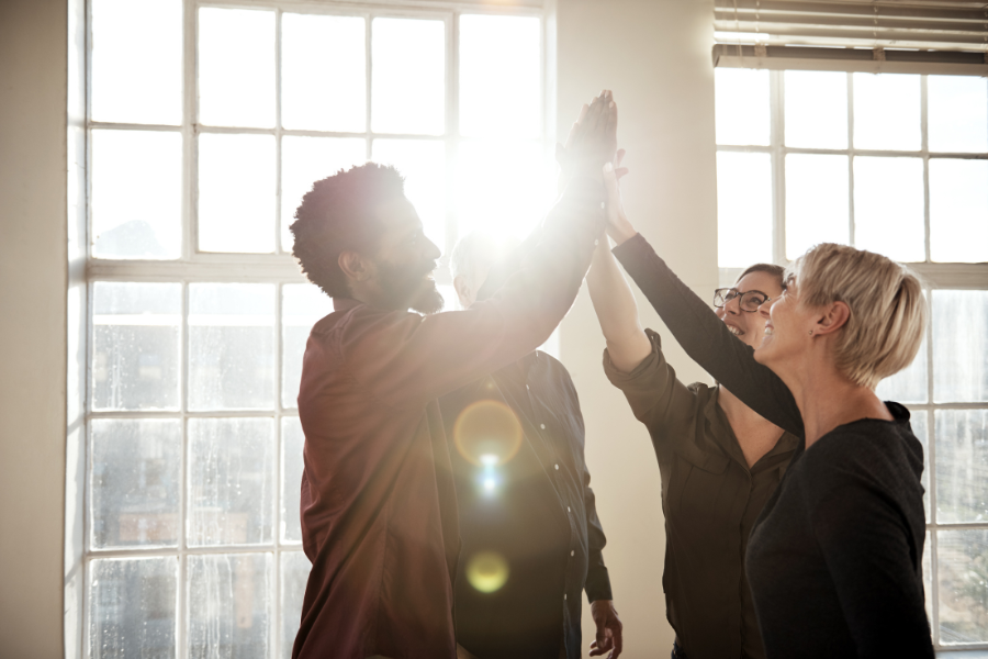Group of people high-fiving each other